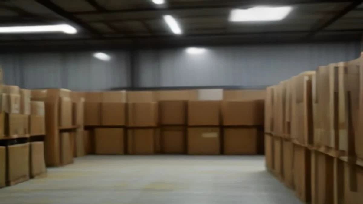 over-the-shoulder view of a modern warehouse aisle with neatly stacked cartons and a clipboard on a pallet — illustrative photograph for this article
